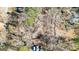 Aerial view showcases the home's positioning on a wooded lot at 6255 James Rd, Austell, GA 30168