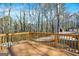 Open deck providing a great view and access to outbuildings, framed by a wooden safety railing at 6255 James Rd, Austell, GA 30168