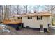 Rear exterior view of the home featuring a deck, lower-level access, and a well-maintained yard at 6255 James Rd, Austell, GA 30168
