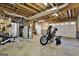 The unfinished basement features exposed beams, a water heater, and a motorcycle at 6255 James Rd, Austell, GA 30168