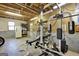 The unfinished basement has exposed beams, gym equipment, and a concrete floor at 6255 James Rd, Austell, GA 30168