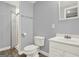 Bathroom features gray-toned walls, dark wood-look flooring, a sink, and a shower at 6255 James Rd, Austell, GA 30168