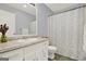 Bathroom featuring a white vanity, toilet, and green and white shower curtain at 6255 James Rd, Austell, GA 30168