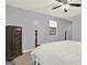 Bedroom featuring a wooden bed frame, dresser, white bedding, and light gray walls at 6255 James Rd, Austell, GA 30168
