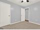 Bedroom featuring light gray walls, carpet flooring, and white trim at 6255 James Rd, Austell, GA 30168