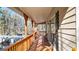 Long, inviting covered porch featuring wood railings and beams, offering an outdoor seating area at 6255 James Rd, Austell, GA 30168