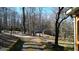 Scenic driveway winding through a wooded area, leading to neighboring houses and the main residence at 6255 James Rd, Austell, GA 30168