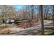 Home situated among trees beside a road at 6255 James Rd, Austell, GA 30168