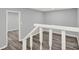 Hallway featuring light gray walls, wood flooring, and white railings at 6255 James Rd, Austell, GA 30168