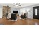 Cozy living room features a stone fireplace, ceiling fan, and lots of natural light at 6255 James Rd, Austell, GA 30168