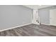 The living room has gray-toned walls, gray wood-look flooring, and an open staircase at 6255 James Rd, Austell, GA 30168
