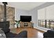 This living room features a stone fireplace, large TV, and natural light at 6255 James Rd, Austell, GA 30168