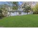 Landscaped backyard with a well-maintained lawn, mature trees, and a white brick home in the background at 2378 Green Forrest Dr, Decatur, GA 30032