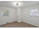 This bedroom boasts neutral carpet, two windows for ample light, a closet and modern light fixture at 2378 Green Forrest Dr, Decatur, GA 30032