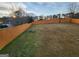 Large backyard with a tall wooden fence and a mix of grass and bare patches at 6160 Great Oaks Dr, Lithonia, GA 30058