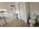Bathroom features a white toilet and sink, as well as tile flooring at 6160 Great Oaks Dr, Lithonia, GA 30058