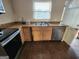 Modest kitchen featuring wood cabinets, stainless steel dishwasher, and double basin sink at 6160 Great Oaks Dr, Lithonia, GA 30058