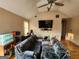 Spacious living room with vaulted ceiling, ceiling fan, hardwood floors, and large couch at 6160 Great Oaks Dr, Lithonia, GA 30058