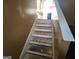 Renovation project showing a staircase with unfinished wooden steps awaiting completion at 6160 Great Oaks Dr, Lithonia, GA 30058