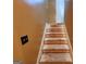 Staircase featuring wood steps and tan colored wall at 6160 Great Oaks Dr, Lithonia, GA 30058