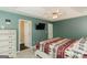 This bedroom features neutral carpet, tray ceiling, and a statement comforter at 31 Wyngate Ct, Dallas, GA 30157