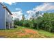 Backyard with seating area and view of treeline at 275 Bramble Bush Trl, Covington, GA 30014