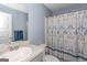 Cozy bathroom featuring a marble vanity top and a patterned shower curtain at 275 Bramble Bush Trl, Covington, GA 30014