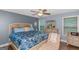 Bright bedroom features a patterned blue comforter, neutral walls, and a ceiling fan at 275 Bramble Bush Trl, Covington, GA 30014