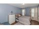 Neutral-toned bedroom with natural light, windows and patterned comforter at 275 Bramble Bush Trl, Covington, GA 30014