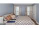 Neutral-toned bedroom with natural light, windows and patterned comforter at 275 Bramble Bush Trl, Covington, GA 30014