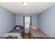 Comfortable bedroom featuring two beds and natural light from a window at 275 Bramble Bush Trl, Covington, GA 30014