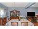 Bright and airy dining room featuring a large dining table and hardwood floors at 275 Bramble Bush Trl, Covington, GA 30014