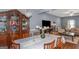 Open-concept dining room and living room featuring a large dining table and stylish decor at 275 Bramble Bush Trl, Covington, GA 30014