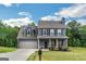 Charming two-story home with blue siding, a well-manicured lawn, and an attached garage with lovely curb appeal at 275 Bramble Bush Trl, Covington, GA 30014