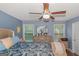 Relaxing main bedroom with ceiling fan, hardwood floors, natural light, and large dresser at 275 Bramble Bush Trl, Covington, GA 30014