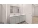 Bathroom with double vanity, white cabinets, and a large mirror at 8595 Secretariat Dr # 19, Lithonia, GA 30058