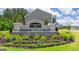 Elegant stone community entrance sign nestled among vibrant flowers and manicured greenery; a warm welcome home at 8595 Secretariat Dr # 19, Lithonia, GA 30058