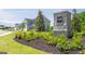 Community entrance sign with lush landscaping and charming homes in the background, a welcoming neighborhood at 8595 Secretariat Dr # 19, Lithonia, GA 30058