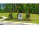 Stone community sign surrounded by lush greenery and manicured lawns; a welcoming entrance to a beautiful neighborhood at 8595 Secretariat Dr # 19, Lithonia, GA 30058