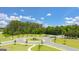 Landscaped roundabout with lush green trees and a clear blue sky in a beautiful neighborhood at 8595 Secretariat Dr # 19, Lithonia, GA 30058