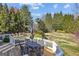Wooden back deck with outdoor dining table and chairs overlooking a lush green backyard at 4569 Chatsworth Ovrlk Ne, Roswell, GA 30075