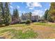 Spacious backyard with grassy area and treeline view of the home's exterior elevation at 4569 Chatsworth Ovrlk Ne, Roswell, GA 30075