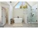 Modern bathroom features a soaking tub, glass shower, and vaulted ceilings at 4569 Chatsworth Ovrlk Ne, Roswell, GA 30075