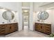 Bathroom with dual vanities, framed mirrors, and tiled floors at 4569 Chatsworth Ovrlk Ne, Roswell, GA 30075