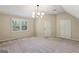 Large carpeted bedroom with natural light, closet and modern light fixture at 4569 Chatsworth Ovrlk Ne, Roswell, GA 30075