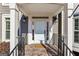 Close up of a charming front entrance with a welcome mat and black handrails at 4569 Chatsworth Ovrlk Ne, Roswell, GA 30075