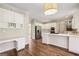 Spacious kitchen with stainless steel appliances, custom cabinets, and adjacent work area at 4569 Chatsworth Ovrlk Ne, Roswell, GA 30075