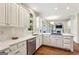 Bright kitchen featuring white cabinets, subway tile backsplash, and stainless steel dishwasher at 4569 Chatsworth Ovrlk Ne, Roswell, GA 30075