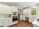 Well-lit kitchen featuring white cabinets and stainless steel appliances at 4569 Chatsworth Ovrlk Ne, Roswell, GA 30075