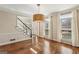 Bright living room featuring hardwood floors, large windows, and staircase at 4569 Chatsworth Ovrlk Ne, Roswell, GA 30075